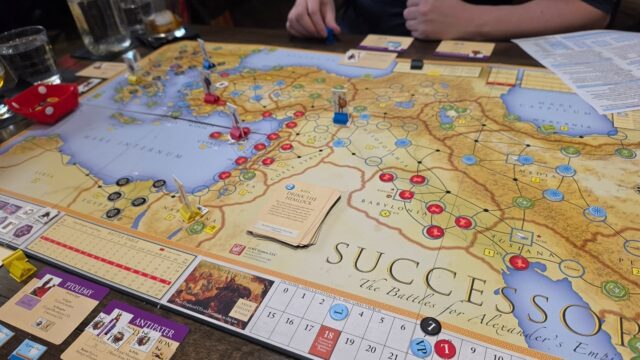 Today's game day was spent learning how to play Successors. Man, what a fantastic game! Alexander the Great has died, but he didn't decide on an heir to mext rule his empire. Players are trying to establish legitimacy to the throne or conquer enough regions. It's a card-driven game that can go for five turns, where cards are played for events or operation points, or both.

---

I started with the general that had Alexander's body, which you can bury in Macedonia all the way across the other side of the map for a lot of points, or you can just hunker down and bury him anywhere in the desert and defend that location for the rest of the game. I lost Alexander in the third round to an opponent but the game ended in the fourth round with the third player gaining all the VPs and Alexander IV coming of age. Our 3P game took about 4 hours. 

"Alexander the Great
His name struck fear into hearts of men
Alexander the Great
He died of fever in Babylon"

#boardgames #boardgamegeek #bgg #tabletopgames #wargames